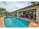 Gorgeous backyard pool with covered patio, perfect for entertaining and enjoying waterfront living at 1038 Contento St, Sarasota, FL 34242