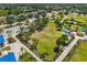 Aerial view showcasing a lush green park with a dog park, benches and seating areas for residents at 11634 Piedmont Park Xing, Bradenton, FL 34211