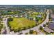 Expansive aerial view highlighting community park with various amenities, sports fields, and green spaces at 11634 Piedmont Park Xing, Bradenton, FL 34211