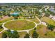 Aerial view of the community park showcasing tennis courts, playground, and manicured green space at 11634 Piedmont Park Xing, Bradenton, FL 34211