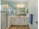 Bathroom features a glass door shower, a double sink vanity and tiled flooring at 11634 Piedmont Park Xing, Bradenton, FL 34211