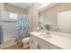 Bright bathroom features a white vanity, decorative shower curtain, and wood-look flooring at 11634 Piedmont Park Xing, Bradenton, FL 34211
