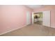 Pink bedroom opens to the kitchen with an open door with carpet throughout the room at 11634 Piedmont Park Xing, Bradenton, FL 34211
