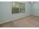 Light blue bedroom features a window with natural lighting and beige carpeting at 11634 Piedmont Park Xing, Bradenton, FL 34211