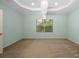 Bedroom with light blue walls and beige carpeting features a decorative ceiling at 11634 Piedmont Park Xing, Bradenton, FL 34211