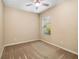 Neutral bedroom with cozy carpet, ceiling fan, and natural light from the window at 11634 Piedmont Park Xing, Bradenton, FL 34211