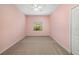 This pink bedroom features carpet, natural lighting, a ceiling fan and a standard closet at 11634 Piedmont Park Xing, Bradenton, FL 34211