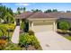 Charming single-story home featuring a two-car garage, well-manicured landscaping, and a concrete driveway at 11634 Piedmont Park Xing, Bradenton, FL 34211