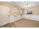 Bright foyer with front door, wainscoting and tan carpet at 11634 Piedmont Park Xing, Bradenton, FL 34211