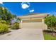 Charming single-story home featuring a tan exterior, well-manicured landscaping, and an attached two-car garage at 11634 Piedmont Park Xing, Bradenton, FL 34211
