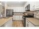 Well-appointed kitchen featuring white cabinets, stainless steel appliances, and tile backsplash at 11634 Piedmont Park Xing, Bradenton, FL 34211
