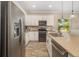 Modern kitchen boasts stainless steel appliances, ample cabinetry, and tan granite countertops at 11634 Piedmont Park Xing, Bradenton, FL 34211