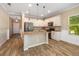 Well-lit kitchen featuring stainless steel appliances, granite countertops, and wood-look tile flooring at 11634 Piedmont Park Xing, Bradenton, FL 34211
