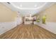 Expansive living space showing wood-look flooring, wainscoting, and open floor plan at 11634 Piedmont Park Xing, Bradenton, FL 34211