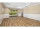 Open living room features wood-look floors, and sliding glass doors to a patio at 11634 Piedmont Park Xing, Bradenton, FL 34211
