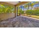Paver patio with a screen enclosure and views of tropical landscaping at 11634 Piedmont Park Xing, Bradenton, FL 34211