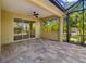 Covered patio with brick floors, a ceiling fan and views of tropical landscaping at 11634 Piedmont Park Xing, Bradenton, FL 34211