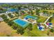Aerial view showcasing community tennis courts surrounded by lush landscaping and neighborhood amenities at 11634 Piedmont Park Xing, Bradenton, FL 34211