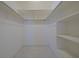 White walk-in closet features shelving and racks to organize your wardrobe at 1223 De Narvaez Ave, Bradenton, FL 34209