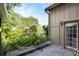 Secluded backyard with a private entrance and a water view beyond the foliage at 1502 Water Oak S Way, Bradenton, FL 34209