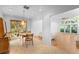 Bright dining area with tile floors, modern lighting, and access to a large living room with vaulted ceilings at 1502 Water Oak S Way, Bradenton, FL 34209