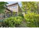 Exterior shot of home featuring an abundance of windows and lush tropical landscaping at 1502 Water Oak S Way, Bradenton, FL 34209