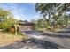 A well-maintained front yard with mature trees and an attached two-car garage at 1502 Water Oak S Way, Bradenton, FL 34209