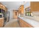 Well-lit kitchen featuring stainless steel appliances, ample counter space, and classic cabinetry at 1502 Water Oak S Way, Bradenton, FL 34209