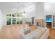 Sunlit living room with large windows, fireplace, high ceilings and comfortable seating at 1502 Water Oak S Way, Bradenton, FL 34209