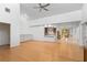 Bright open-concept living room featuring a ceiling fan, bar area, and dining space nearby at 1502 Water Oak S Way, Bradenton, FL 34209