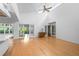 Spacious living room with vaulted ceiling, ceiling fan, and glass doors to the outside at 1502 Water Oak S Way, Bradenton, FL 34209