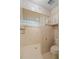 Walk-in shower featuring decorative tiling, glass block accents, and modern fixtures, with a nearby toilet at 1502 Water Oak S Way, Bradenton, FL 34209