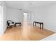 Bright sitting area with hardwood floors, neutral walls, and access to other rooms via glass panel doors at 1502 Water Oak S Way, Bradenton, FL 34209