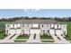 New townhomes with manicured lawns, private garages, and modern gray and white facades create curb appeal at 15117 Cuzcorro Ct, Nokomis, FL 34275
