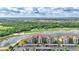 An aerial shot of a large condo building with a golf course and lake view at 17118 Vardon Ter # 304, Bradenton, FL 34211