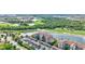 Aerial view of a condo complex next to a lake and golf course, highlighting its picturesque setting at 17118 Vardon Ter # 304, Bradenton, FL 34211