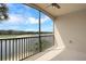 View from the balcony overlooking the golf course and lake with beautiful blue skies at 17118 Vardon Ter # 304, Bradenton, FL 34211