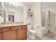 Well-lit bathroom with granite countertop, wood cabinets, and a shower/tub combo at 17118 Vardon Ter # 304, Bradenton, FL 34211