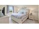 Bedroom with a queen bed, side tables and bedside lamps and a window at 17118 Vardon Ter # 304, Bradenton, FL 34211