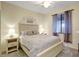 Cozy bedroom with neutral tones, a queen bed, bedside tables, and a window at 17118 Vardon Ter # 304, Bradenton, FL 34211
