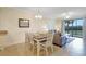 A dining room with a table and seating for six, connecting to a living room with a sofa at 17118 Vardon Ter # 304, Bradenton, FL 34211