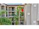 Close view of the building exterior, showcasing palm trees and balconies at 17118 Vardon Ter # 304, Bradenton, FL 34211