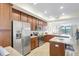 Open kitchen with granite countertops and stainless steel appliances and view to the living area at 17118 Vardon Ter # 304, Bradenton, FL 34211