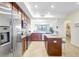 Open kitchen with granite countertops, stainless steel appliances, island, and view to living area at 17118 Vardon Ter # 304, Bradenton, FL 34211