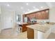 A well-lit kitchen with granite countertops, a center island, and modern appliances at 17118 Vardon Ter # 304, Bradenton, FL 34211