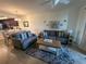 Comfortable living room with tile floors, ceiling fan, and kitchen and dining area in background at 17118 Vardon Ter # 304, Bradenton, FL 34211