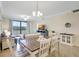 Open concept living and dining area with modern decor and access to outdoor balcony at 17118 Vardon Ter # 304, Bradenton, FL 34211