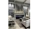 Elegant lounge area with modern fireplace, stylish decor, and comfortable seating at 17118 Vardon Ter # 304, Bradenton, FL 34211