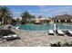 Spacious pool area with multiple waterfalls and lounge chairs on a sunny day at 17118 Vardon Ter # 304, Bradenton, FL 34211