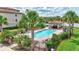 Relaxing pool area with lounge chairs and a covered seating area amidst lush landscaping at 17118 Vardon Ter # 304, Bradenton, FL 34211